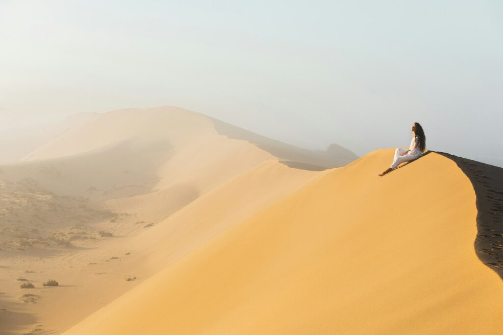 Dream destination, travel and wanderlust concept. Happy woman inspired by fantastic sunrise Sahara