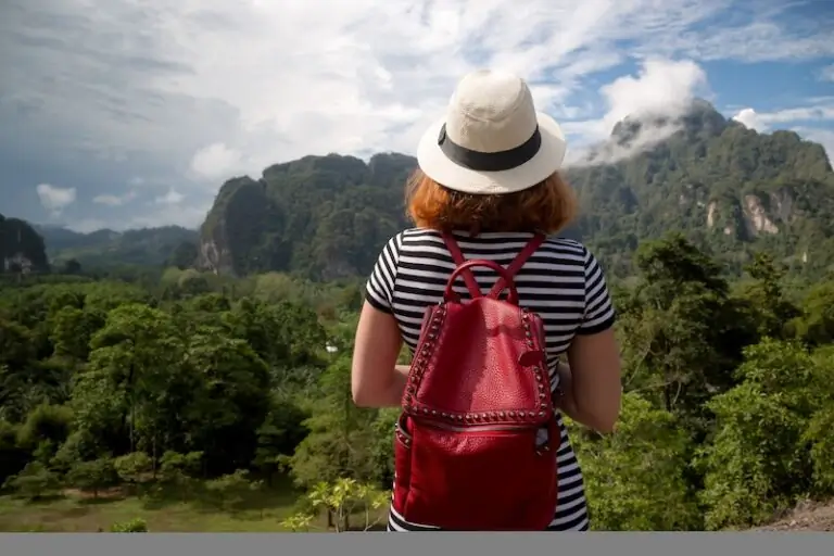 RedHead girl travling with backpack and hat
