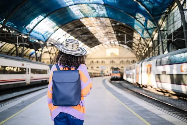 young black woman travling in train station