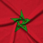 Morocco flag is depicted on a sports cloth fabric with many folds. Sport team waving banner