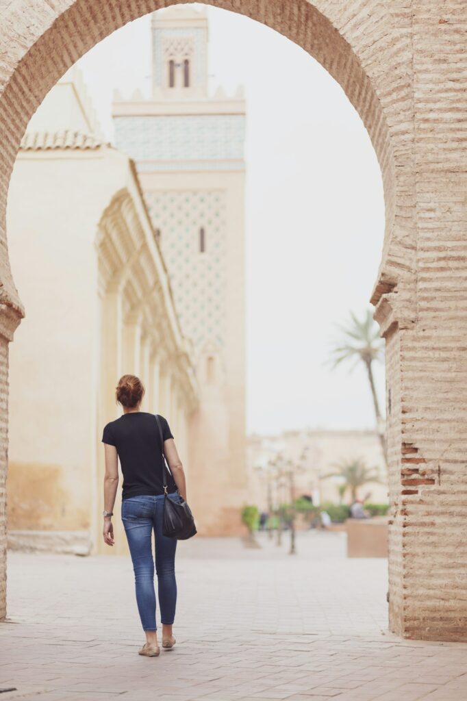 Morocco, Marrakesh, back view of woman looking at Kasbah Mosque